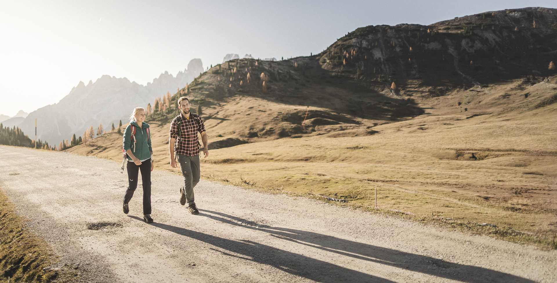 Even a leisurely tour can bring wonderful experiences. 2 hikers in a beautiful autumn landscape