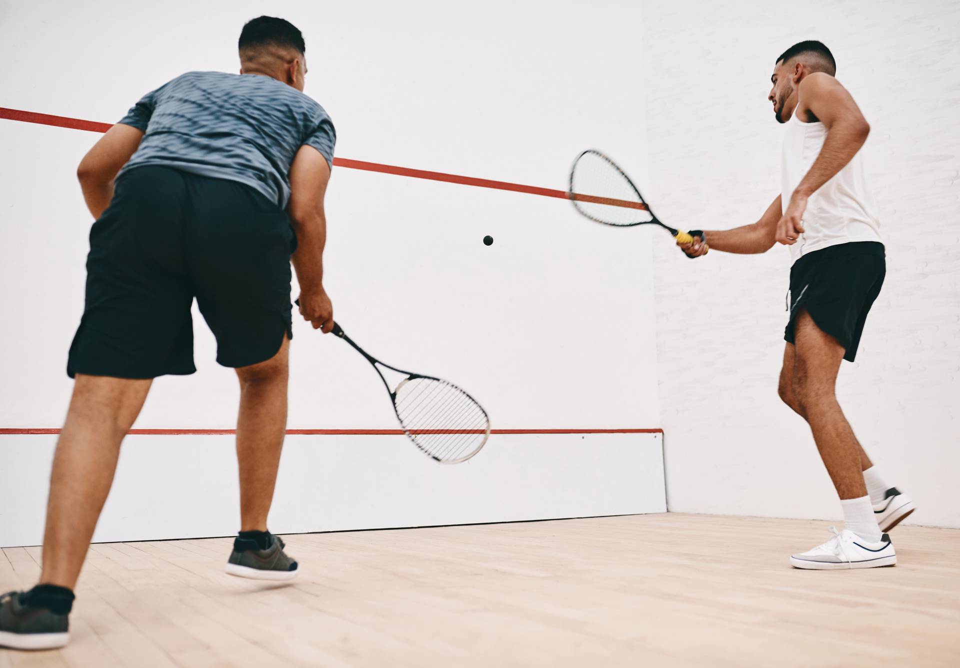 Two people playing squash