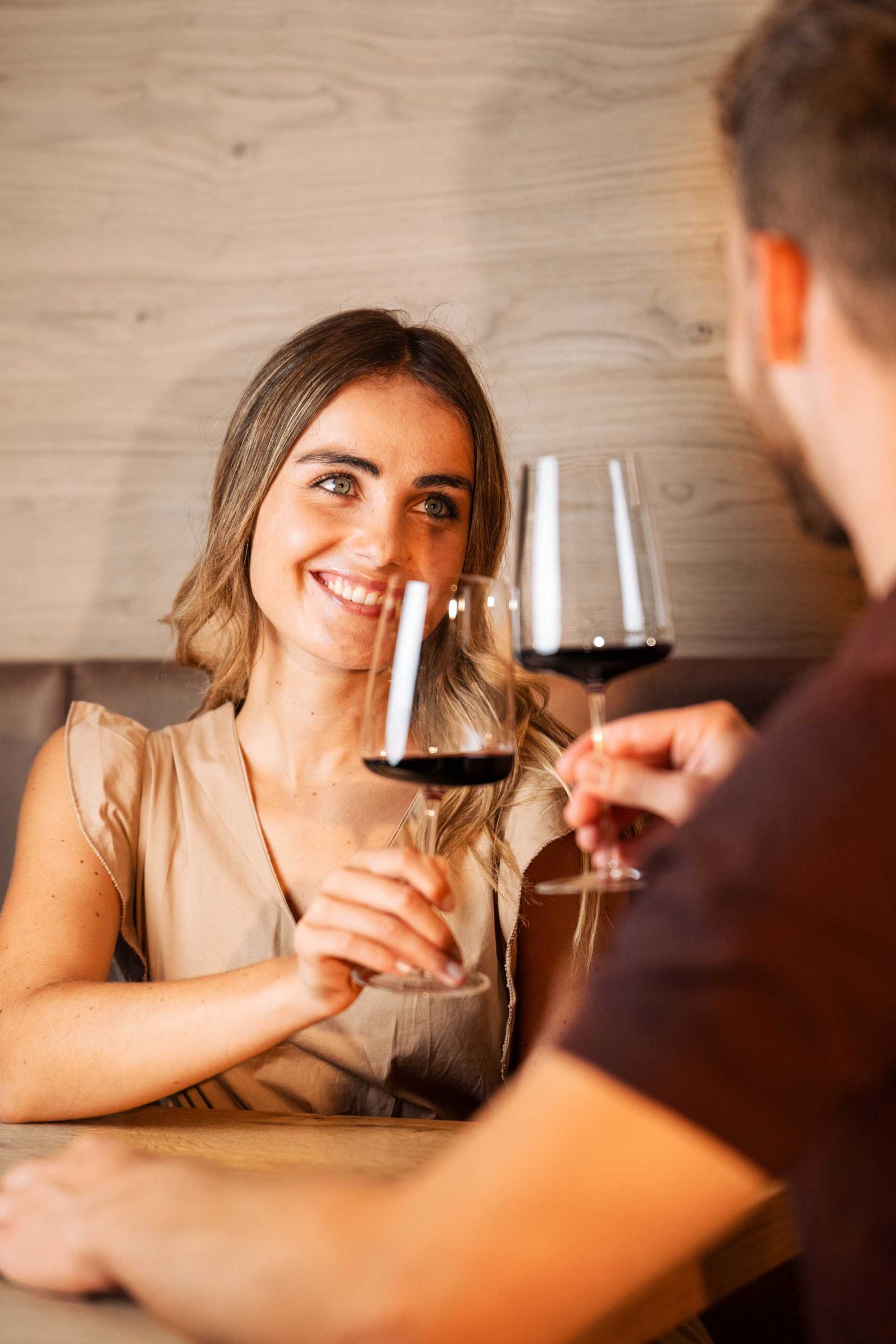 Two people drink a glass of South Tyrolean red wine